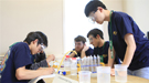 A group of students gathered around a table.