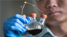 Closeup of a flask being held by a scientist.
