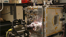 The experimental chamber setup is seen from the front, with high speed camera looking into the chamber from the left.