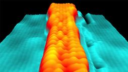 Scanning tunneling microscopy image shows a variable-width graphene nanoribbon. Atoms are visible as individual &ldquo;bumps.&rdquo;