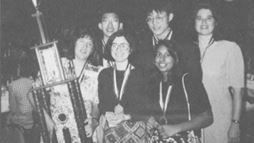 Left to right, in the back: Si Hwang Chin, Peter Chan, Renee Landrum. Front row: coach Penny Sconzo, Susan Born, and Shireen Haque with their 1994 National Science Bowl&reg; trophy.