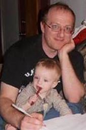 Zach Teitler, shown here grading exams with his son&rsquo;s help, is an associate professor of math at Boise State University. 