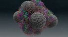 Water is seen as small red and white molecules on large nanodiamond spheres.
