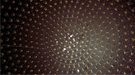 This interior view of the MiniBooNE detector tank shows the array of photodetectors used to pick up the light particles that are created when a neutrino interacts with a nucleus inside the tank.