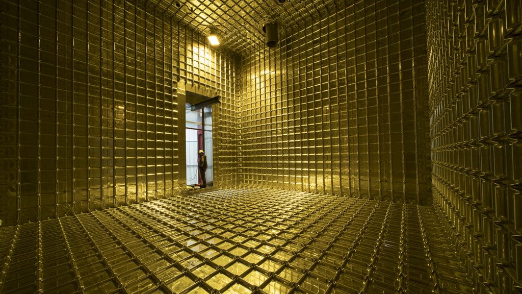 The empty interior of ProtoDUNE takes on a golden hue. Photo: CERN