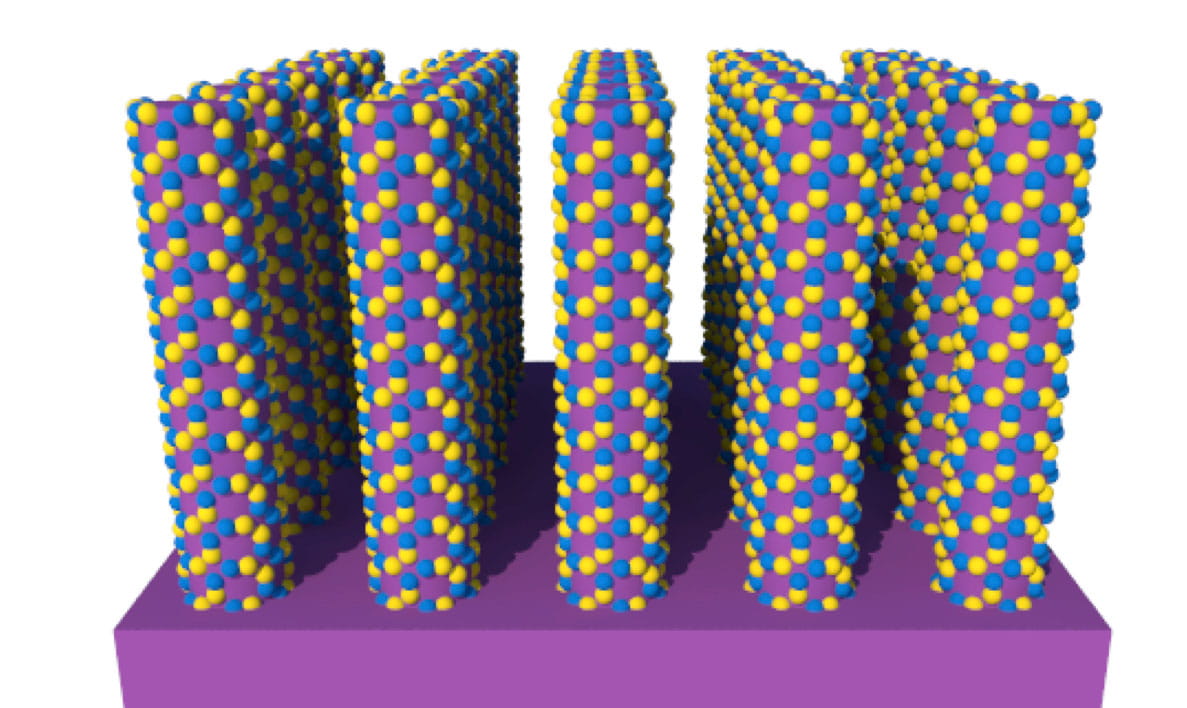 Five rectangular cubes of small purple, yellow and pink spheres standing on end on a purple platform.